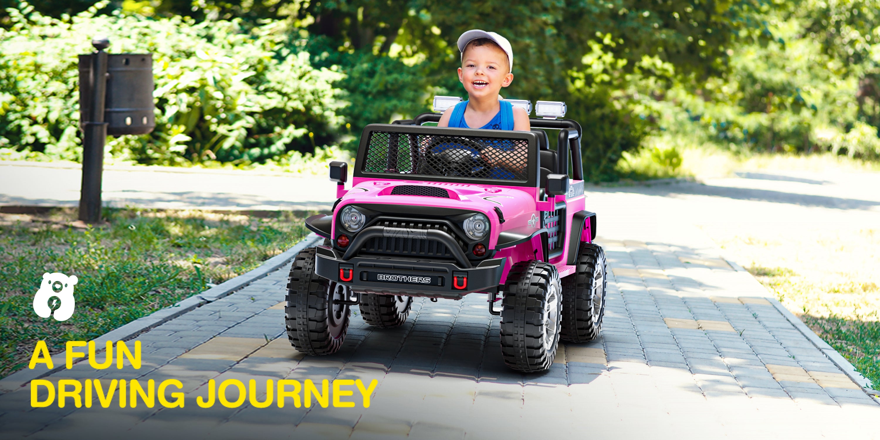 Child driving a pink off-road car on a path with greenery in the background